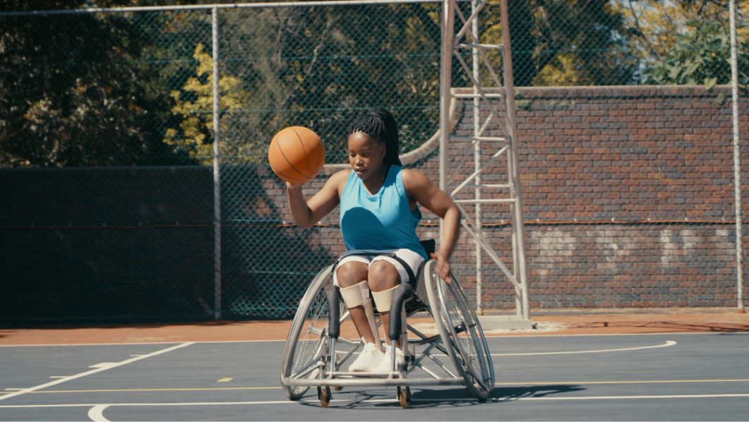 ragazza che gioca a basket in carrozzina