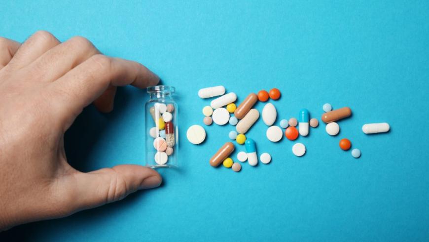 pillole e droghe in boccetta di vetro